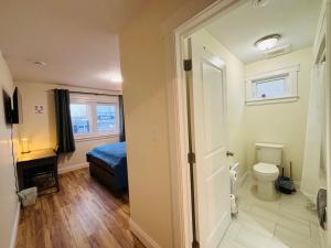 a bathroom with a bed and a toilet in a room at New Guesthouse in Charlottetown +20 photos