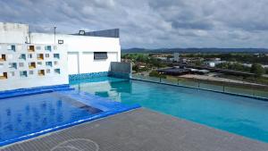 a swimming pool on the roof of a building at Alor Setar Imperio Studio by IM Staycation in Alor Setar
