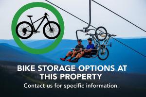 two people riding a bike on a ski lift at Ramshead Creek 1 in Thredbo