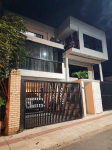 a house with a gate in front of it at Loft 150m da praia in Itajaí