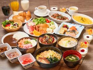 a table with many different dishes of food on it at APA Hotel Hakodate Ekimae in Hakodate +61 photos