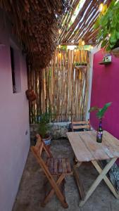 a wooden table and chairs in a room with a table and chairs at Cabaña 2 Los Gallitos Ecolodge in Sacalum