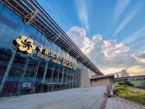 a large building with a sign on the side of it at Yilandu Apartment Hotel Guangzhou Tower Pazhou International Exhibition Center Branch in Guangzhou