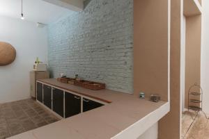 a kitchen with a brick wall and a sink at Villa Monsoon in Mount Lavinia +43 photos