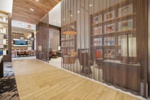 a lobby with wood paneled walls and a room with tables at Penthouse Retreat with Rooftop Pool Explore Silver Spring & Washington DC in Silver Spring