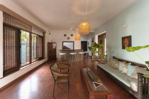 a living room with a couch and a table and chairs at Villa Monsoon in Mount Lavinia
