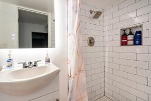 a white bathroom with a sink and a mirror at Updated Apt with Private Entry and FREE Parking in Washington, D.C. +15 photos