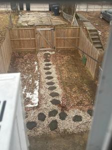 a backyard with a wooden fence and a path at Updated Apt with Private Entry and FREE Parking in Washington, D.C.