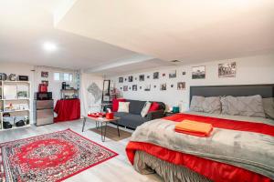 a bedroom with a large bed and a living room at Updated Apt with Private Entry and FREE Parking in Washington, D.C.