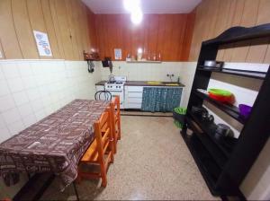 a small kitchen with a table and a stove at Casona Sol in Mar del Plata