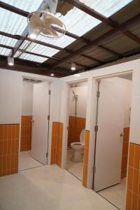 a bathroom with a toilet and a ceiling at Nitra Hostel Siriraj in Bangkok