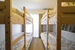 two bunk beds in a room with a window at Chill Place 120 Ayase in Tokyo +87 photos
