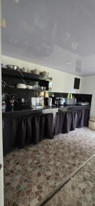 a large kitchen with black tables and pots and pans at Cabinas Nasua Drake in Drake
