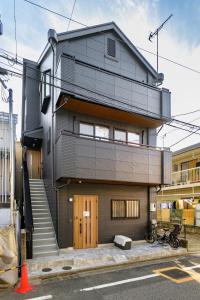 a large building with a staircase on the side of it at Chill Place 120 Ayase in Tokyo