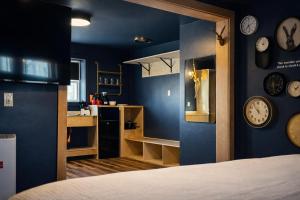 a room with a bed and clocks on the walls at Hotel Expedition in Red Lodge