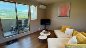 a living room with a couch and a table at 南阿蘇サウナ5gaku G1 in Minami Aso
