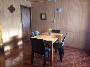 a wooden table with chairs in a room at Hostal Verde Vida in Futrono +30 photos