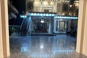 a large lobby with a staircase and a stair case at Hotel Beubelle in Meerut