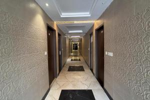 a hallway in a building with a long corridor at Hotel Beubelle in Meerut