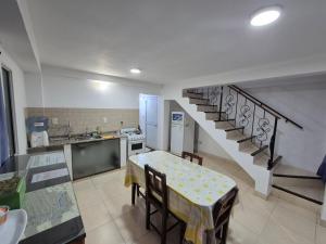 a kitchen with a dining table and a staircase at Departamentos Blazu Cafayate in Cafayate