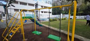 a playground with a slide in a yard at Mount Coco Resort Yercaud in Yercaud