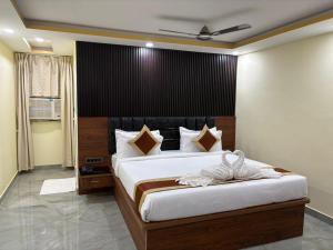 a bedroom with a large bed with a black headboard at Hotel Diamond Crest, Patna in Patna +58 photos