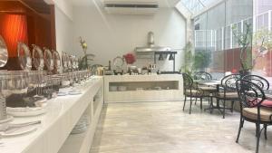 a room with a counter with chairs and a table at Tai Pan Hotel in Bangkok