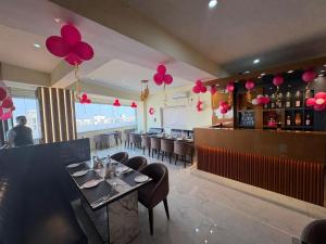 a restaurant with a dining room with red balloons at Hotel Diamond Crest, Patna in Patna
