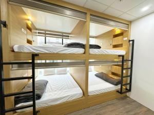 a group of bunk beds in a room at Ha Noi Capsule Station Hostel in Hanoi +17 photos