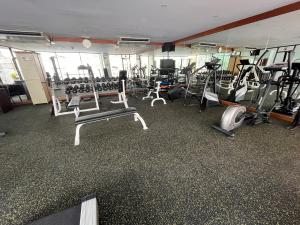 a gym with several treadmills and machines in it at Tai Pan Hotel in Bangkok