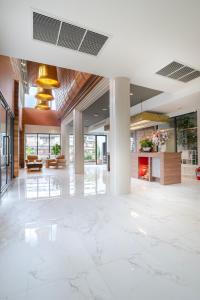 an empty lobby with white marble floors and ceilings at The Chedee Krungthep in Bangkok