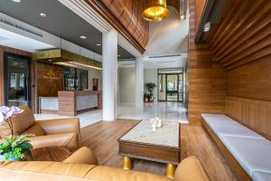 a lobby with a couch and a table at The Chedee Krungthep in Bangkok