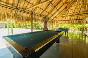 a pool table in a pavilion with a pool table at Paraíso By Elemnt Rentals in Santa Marta