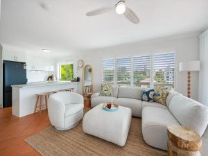 a living room with a couch and a kitchen at Seabreeze unit 5, Kings Beach in Caloundra