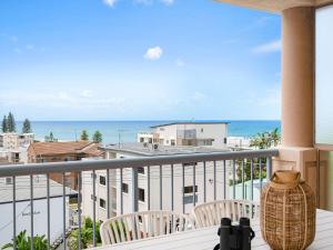 a balcony with chairs and a view of the ocean at Seabreeze unit 5, Kings Beach in Caloundra