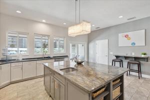 a kitchen with a large island with a counter top at 51 N Orlando Ave in Cocoa Beach +40 photos