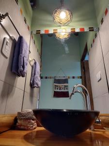 a bathroom with a black sink and a mirror at Cabañas Mónika IV Sur in Huerta Grande +46 photos