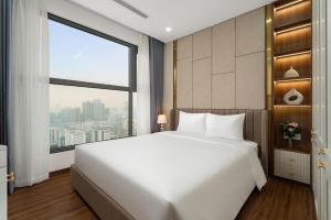 a bedroom with a large white bed and a large window at Aravelle Suites managed by 22Land in Hanoi +54 photos