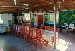 a dining room with a table and chairs at Cabañas Los Culenes in Colbún +72 photos