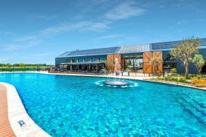 a large swimming pool in front of a building at Lagoon Aparthotel in Pretoria