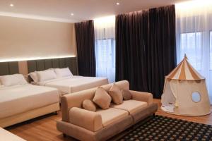 a bedroom with a couch and a bed and a tent at Crystal Crown Hotel Kuala Lumpur in Kuala Lumpur