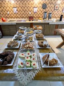 a buffet line with many different types of food at Hotel Perez in Pouso Alegre