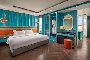 a bedroom with a large bed and a mirror at Minerva Church Hotel in Hanoi +23 photos