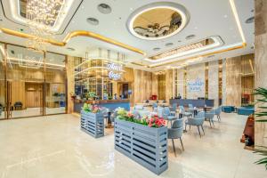a restaurant with blue tables and chairs in a mall at Aravelle Suites managed by 22Land in Hanoi