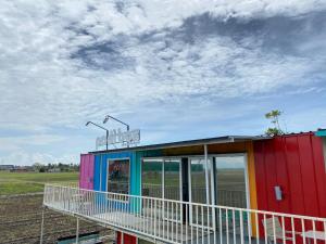 a colorful building with lights on top of it at Padi Box Homestay in Sekinchan