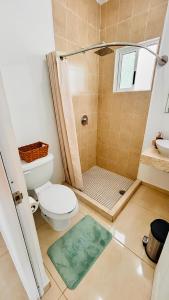 a bathroom with a shower with a toilet and a sink at Casa amplia y privada con alberca para una escapada perfecta in Playa del Carmen +25 photos