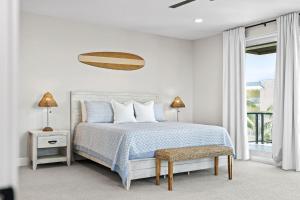 a white bedroom with a bed and a window at 50 8th Avenue in Indialantic