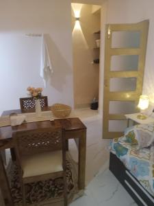 a bedroom with a desk and a bed and a staircase at Beautiful 1-bed Apartment-Suite Kolkata near Airport in Kolkata