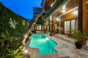 an image of a swimming pool in the backyard of a house at Paisa Ubud in Ubud