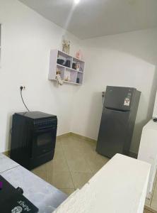a kitchen with a stove and a refrigerator at Ailynes in Diani Beach